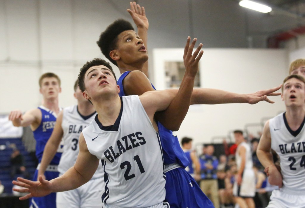 Jeremiah Alado, left, of Westbrook and Max Murray of Kennebunk fight for rebounding position during a Class A South basketball quarterfinal Saturday night at the Expo. Westbrook, the No. 3 seed, advanced with a 53-32 victory.