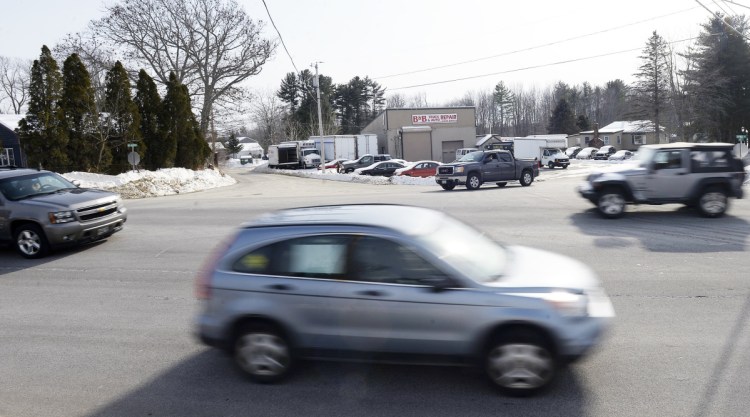 Traffic moves along Route 111 in Arundel on Feb. 9 as a pickup waits to pull out from New Road. The Maine Department of Transportation is moving forward with projects to address safety concerns along the busy corridor between Sanford and Biddeford in York County.