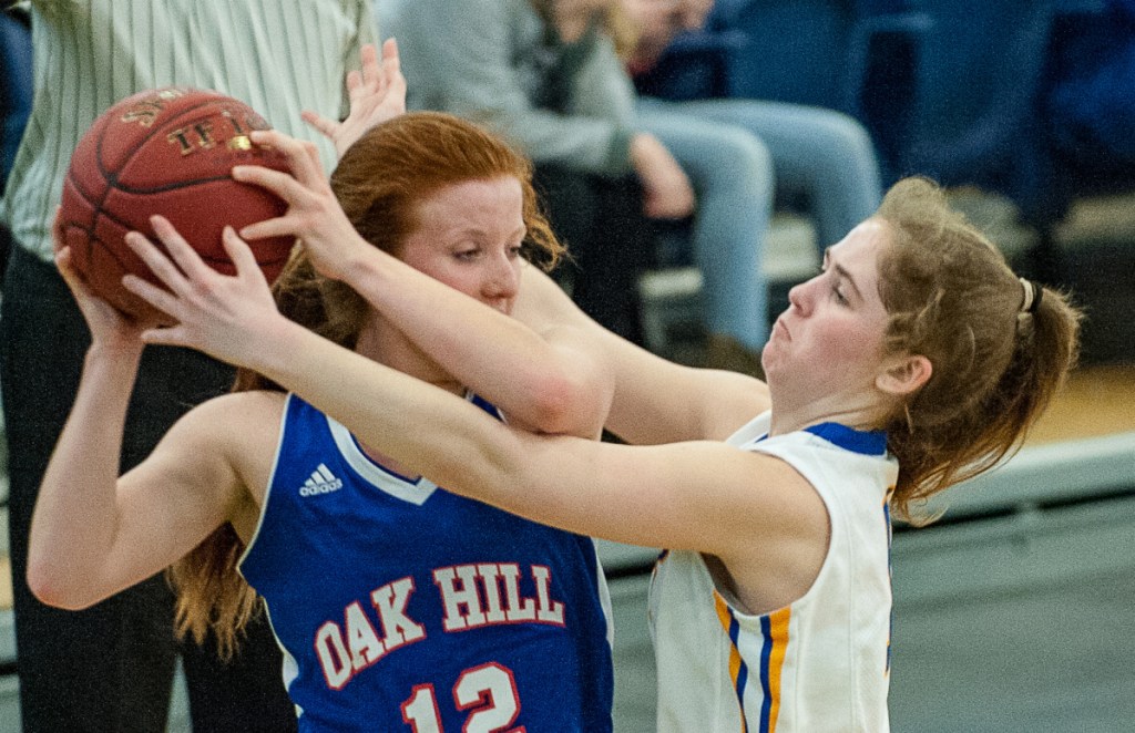Lake Region High's Rachel Shanks pressures Oak Hill's Sadie Waterman in the backcourt during Tuesday's Class B South girls' basketball quarterfinal at the Portland Expo. (Russ Dillingham/Sun Journal)
