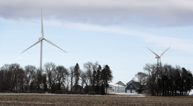 Turbines tower over a farmhouse near Northwood, Iowa. A newly invigorated rebellion against wind power is raising a host of anti-wind ideas.