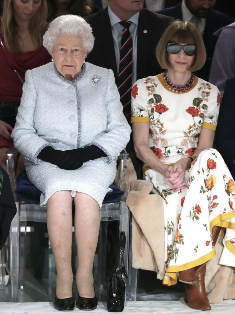 Britain's Queen Elizabeth sits next to Vogue editor Anna Wintour during London's Fashion Week on Tuesday.