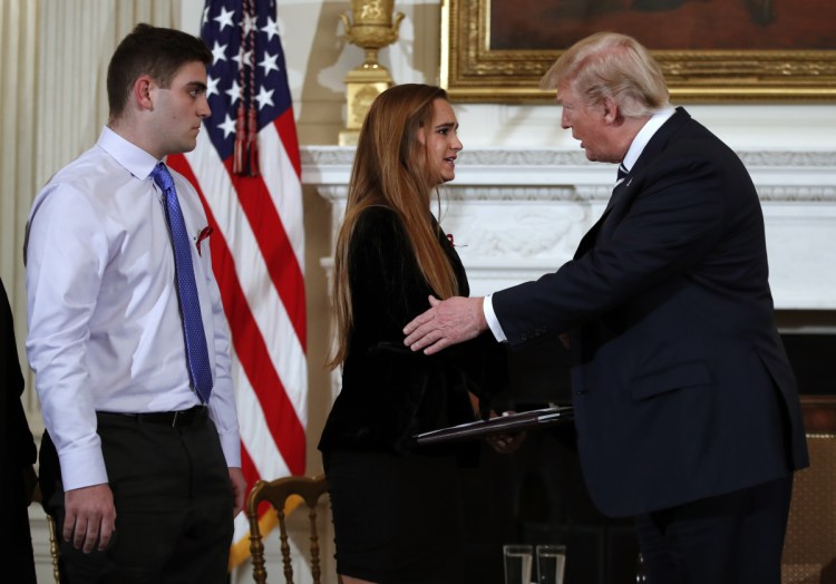 President Trump greets Julia Cordover, the student body president at Marjory Stoneman Douglas High School in Parkland, Fla., at a listening session with high school students and teachers on Wednesday at the White House. Behind Cordover is fellow student Jonathan Blank.