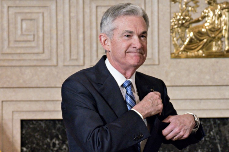 Fed Chairman Jerome Powell puts away his glasses after taking the oath of office in Washington on Feb. 5, 2018. MUST CREDIT:.