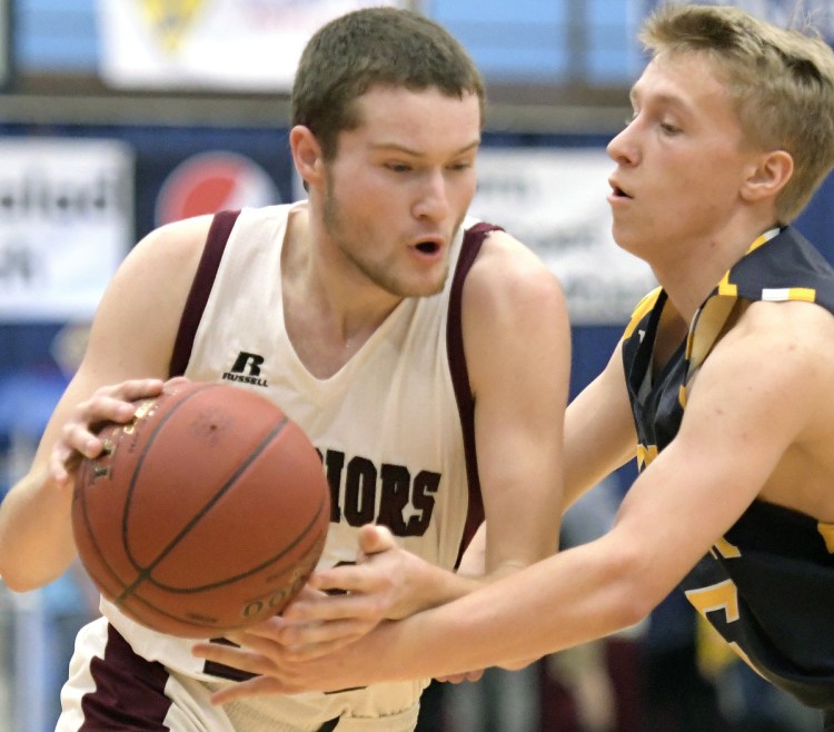 Zach Hartsgrave of Nokomis is defended by Medomak Valley's Christopher Bowman during a Class A North boys' basketball semifinal Wednesday night at the Augusta Civic Center. Medomak advanced to the regional final with a 49-44 victory.