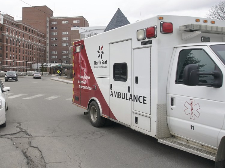 A North East Mobile Health Services ambulance leaves Maine Medical Center in Portland on Friday. North East and the hospital have agreed to settle federal claims of improper billing.