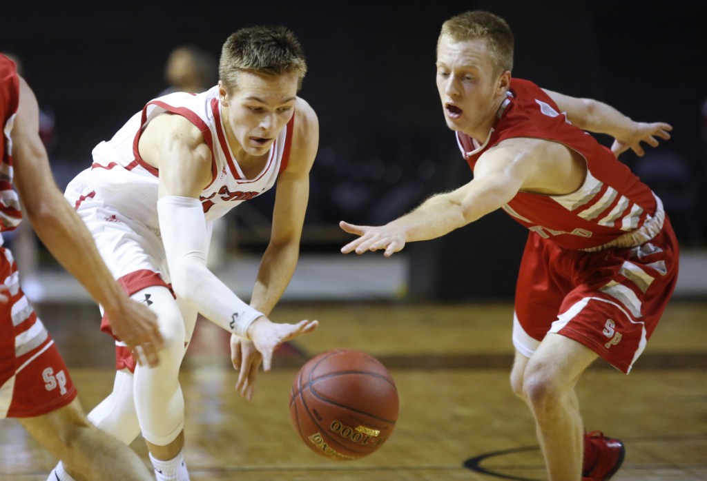 Connor Buckley of South Portland reaches to try and steal the ball from Morgan Pratt of Scarborough in the first half of the Class AA South final Friday at Cross Insurance Arena. Scarborough won 55-43 to reach the state final.