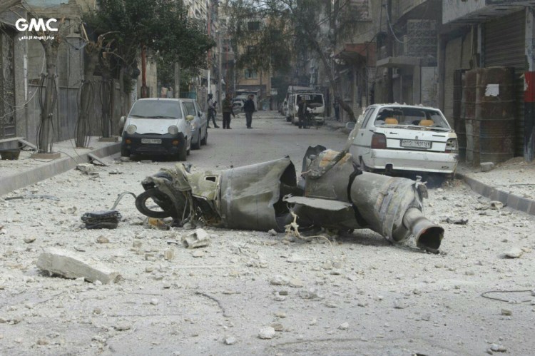 An anti-government activist group in Syria released this photograph Friday showing the remains of a missile lying on a street in Ghouta.