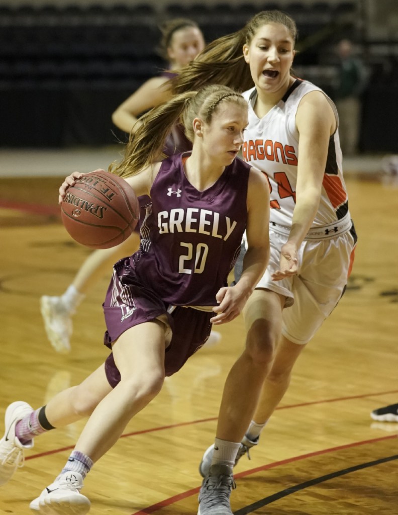 Greely's Anna DeWolfe maneuvers around Brunswick's Alexis Guptil during the Class A South girls' basketball regional final at the Cross Insurance Arena in Portland on Saturday. Greely won, 66-49, and will play for a state title on Thursday.