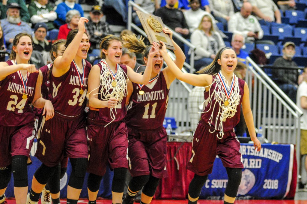 Monmouth Academy players celebrate their 51-47 win over Boothbay in the Class C South girls' basketball final Saturday night at the Augusta Civic Center.