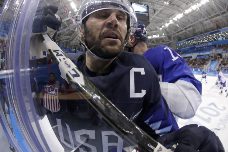 Brian Gionta is checked by Tomas Starosta of Slovakia during the third period of a men's hockey game at the 2018 Winter Olympics in Gangneung, South Korea. Gionta signed a one-year deal with the Bruins on Sunday.