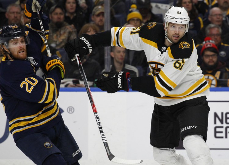Buffalo forward Scott Wilson is checked by Boston forward Rick Nash during the third period of the Bruins' 4-1 loss on Sunday in Buffalo, New York. Nash was acquired by the Bruins on Sunday morning in a trade with the New York Rangers.