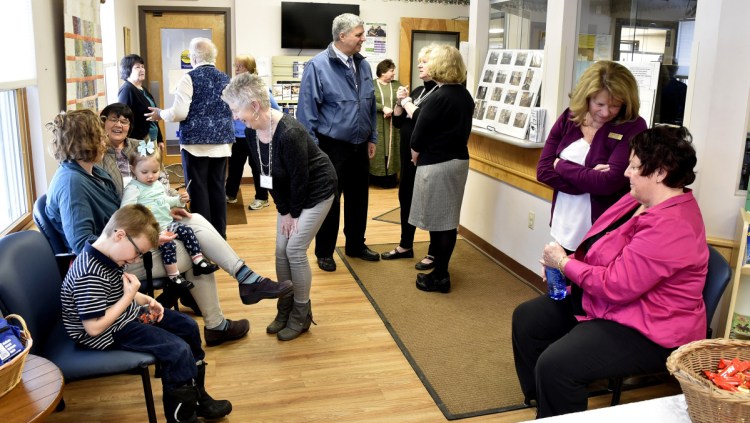 People attending the recently renovated Lovejoy Health Center in Albion socialize in a patient waiting area during an open house Sunday.