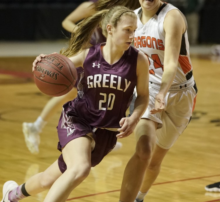 Greely's Anna DeWolfe maneuvers around Brunswick's Alexis Guptil during the Class A South regional final basketball game at the Cross Insurance Arena in Portland on Saturday, February 24, 2018.