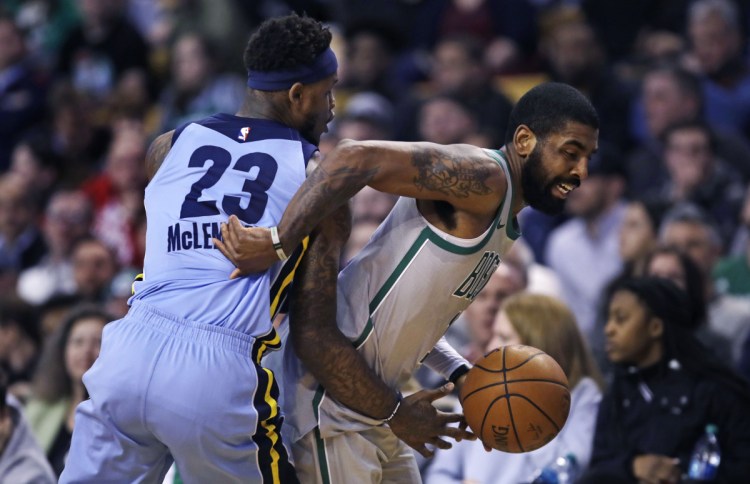 Memphis Grizzlies guard Ben McLemore tries to stop Boston Celtics guard Kyrie Irving, right, during the Celtics' 109-98 win Monday in Boston.