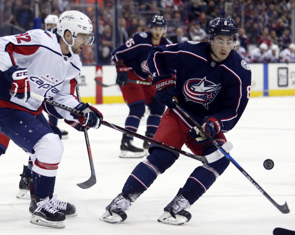 Capitals forward Evgeny Kuznetsov, left, passes the puck while Blue Jackets defenseman Zach Werenski closes in during the first period of Columbus' 5-1 win Monday in Columbus, Ohio.