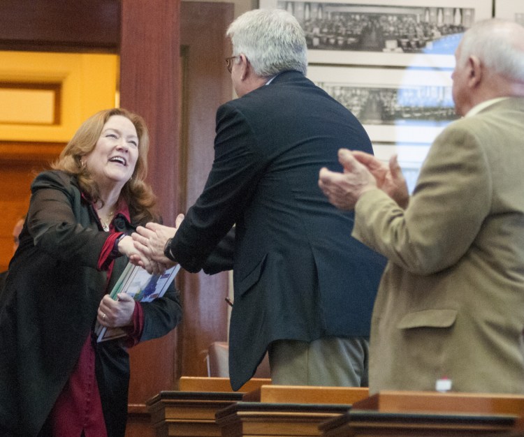 Maine Chief Justice Leigh Saufley greets Rep. Robert Foley, R-Wells, as she enters the House chamber to give her annual address Tuesday in Augusta. She said the pilot program would include addiction treatment, mental health services, job training, sober housing and other services.