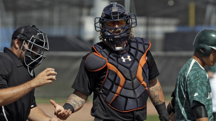 Jarrod Saltalamacchia, center, is one of the players you might recognize playing in games with other free agents in Florida, hoping for a chance to impress a scout and get a job somewhere, even in the minor leagues