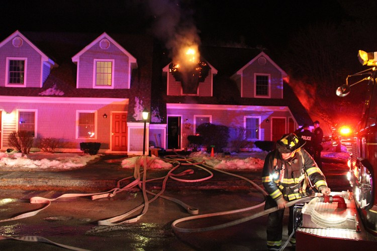 Firefighters work at the scene of a fire at 175 Rankin St. in Rockland Monday evening.