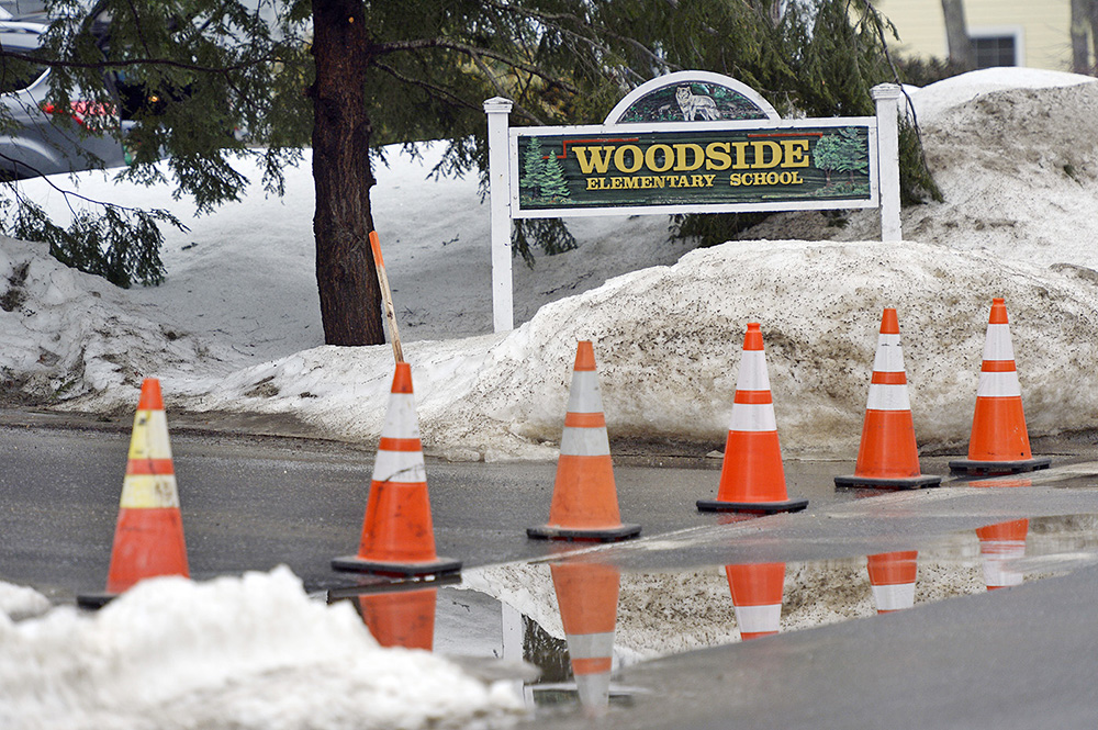 Cones block the entrance to Woodside Elementary School in Topsham after its evacuation Friday morning.