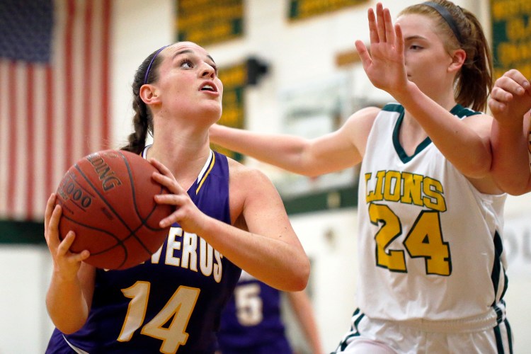 Abby Cavallaro of Cheverus looks for room under the basket as Maine Girls' Academy's Emily Weisser defends.