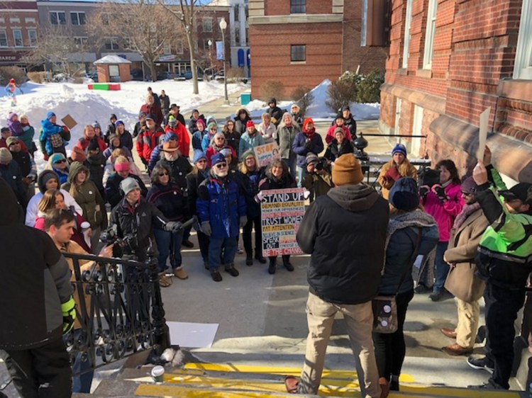 A crowd outside City Hall in Waterville listens on Saturday as John Reynolds, Mindy Saint Martin's brother, speaks about U.S. Customs and Immigration Enforcement officials' seizure of his brother-in-law, Lexius Saint Martin, who arrived in the United States as a child and is expected to be deported to his native Haiti.