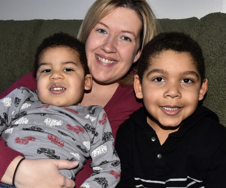 Mindy Saint Martin holds her sons Marcus, left, and Donovan at their home in Waterville on Jan. 29, 2018. Mindy's husband Lexius was deported to Haiti Tuesday morning.