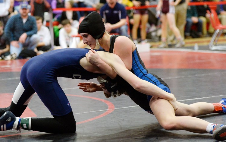Zoe Buteau, top, of Lisbon/Oak Hill, wrestles with Ashton James of Calais in the consolation semifinals at the Class B Maine state wrestling championships in 2018. This year Maine girls got their own wrestling state championship.