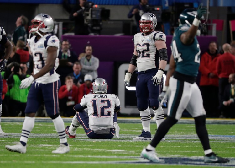 New England quarterback Tom Brady sits on the turf after fumbling the ball with 2:16 remaining in the Patriots' 41-33 loss to the Philadelphia Eagles in the Super Bowl on Sunday.