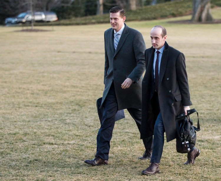 Former White House staff secretary Rob Porter, left, walks with White House senior adviser Stephen Miller from Marine One across the South Lawn of the White House on Feb. 5, as they return with President Trump from Ohio.