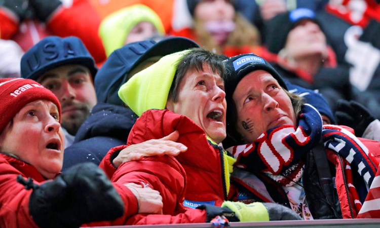 Sue Sweeney, center, the mother of Emily Sweeney of the United States, cries out as her daughter crashes on the final run during the women's luge final Tuesday.