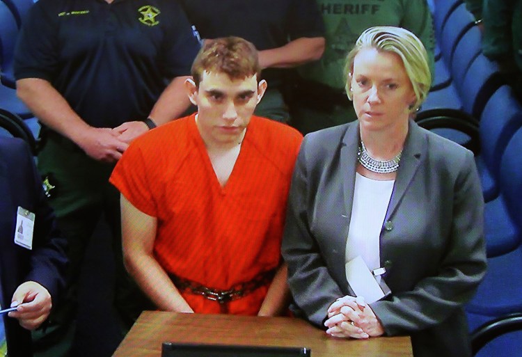 A video monitor shows school shooting suspect Nikolas Cruz making an appearance in Broward County Court on Feb. 15, 2018, in Fort Lauderdale, Florida. 