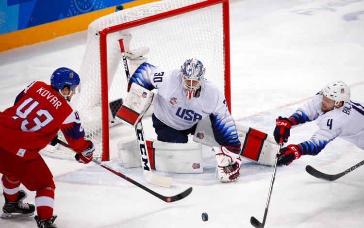 U.S. goalie Ryan Zapolski guards the goal as Jan Kovar of the Czech Republic and Chad Billins, of the U.S., battle for the puck during the first period Wednesday. 