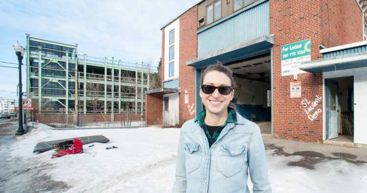 Kara Wilbur stands in front of the former Lewiston Fire Department substation on Lincoln Street on Monday afternoon. She and business partner Paul Peck hope to renovate it and attract a restaurant or brewery for the first floor. 