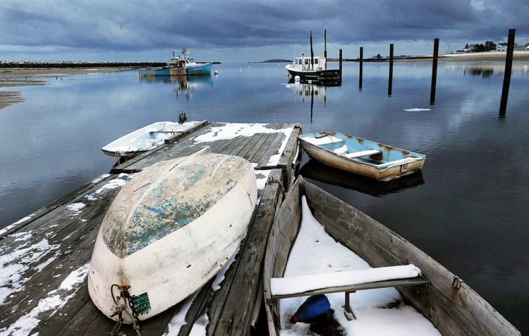 Storm clouds roll in over dinghies tied up at docks along the Saco River in Camp Ellis.