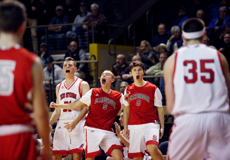 Scarborough vs South Portland Class AA South final. Scarborough teammates Zoltan Panyi, left, Alexander Austin and Sam Gorey celebrate from the bench after Nicholas Fiorillo scored in the fourth quarter of the Class AA South regional basketball final. Staff photo by Derek Davis