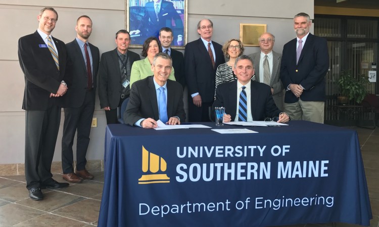 University of Southern Maine President Glenn Cummings, seated left, and Southern Maine Community College President Ron Cantor are joined by the chairs of both schools’ engineering departments – USM’s Mariusz Jankowski, third from left, and SMCC’s Adam Tambone, center  – at the signing of the schools’ 2 + 2 program agreement in April 2017. Also shown, from left rear, are USM’s Carlos Lück, associate professor of electrical engineering; Andrew King, admissions director; Meghan Cadwallader, educational partnerships director; James Graves, dean of the College of Science, Technology and Health; Jeannine Uzzi, provost; and Mustafa Guvench, professor of electrical engineering. At right is Charles Gregory, SMCC interim dean of academics.