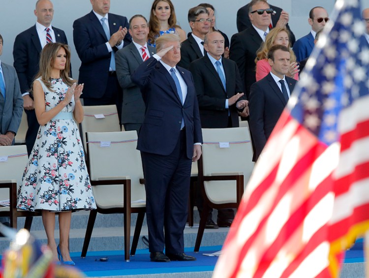 Donald and Melania Trump watch the traditional Bastille Day military parade  with French President Macron on the Champs Elysees, in Paris in 2017.