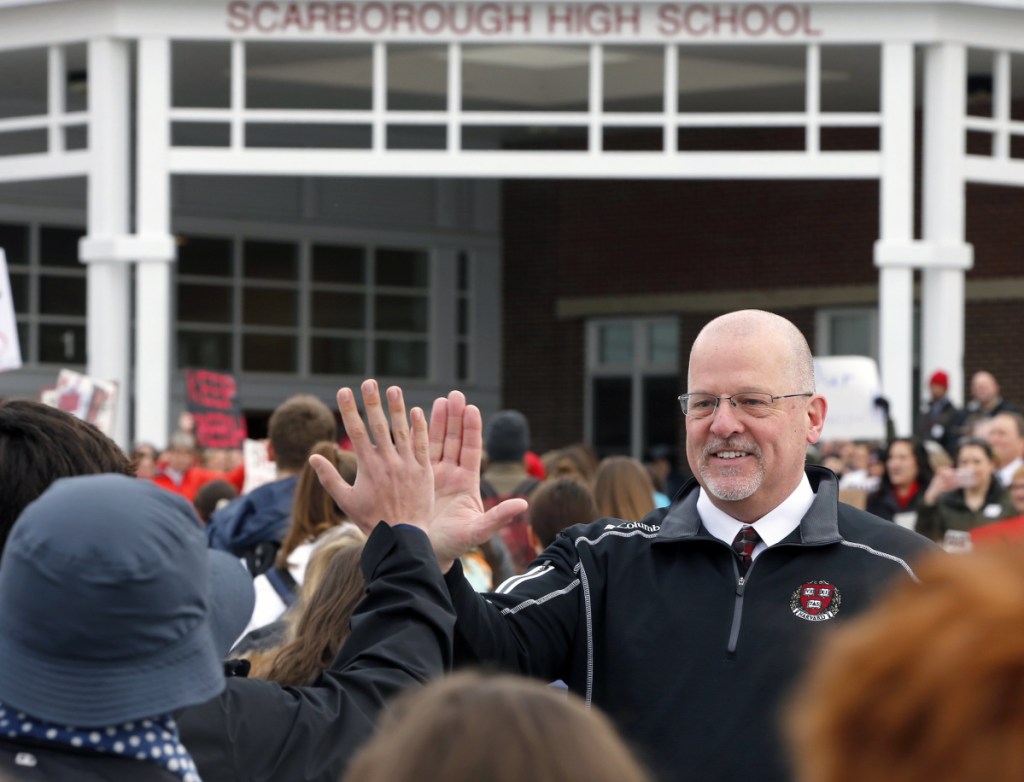 Principal David Creech greets students arriving at Scarborough High School on Monday. On Thursday, hundreds of people of packed a school board meeting in support of the embattled principal.