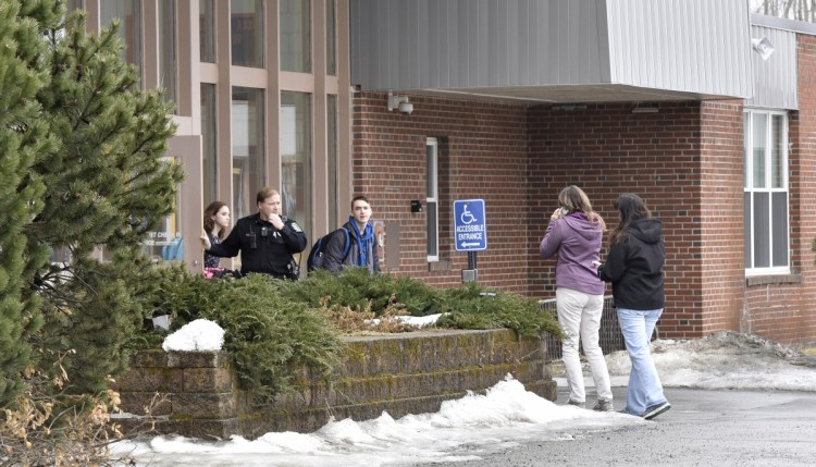 SAD 54 School Resource Officer David Daigneault speaks with parents as students exit Skowhegan Area High School during a lockout after a threat made Thursday. It was the second threat there this week. Students were allowed to leave the school, but no one was allowed to enter.