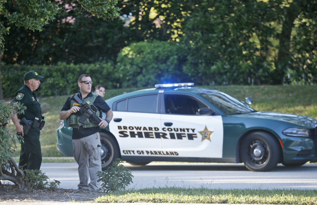 Officers stand outside Marjory Stoneman Douglas High School on Feb. 14. Dispatch logs raise questions about the handling of the shooting at the Parkland, Fla., school.