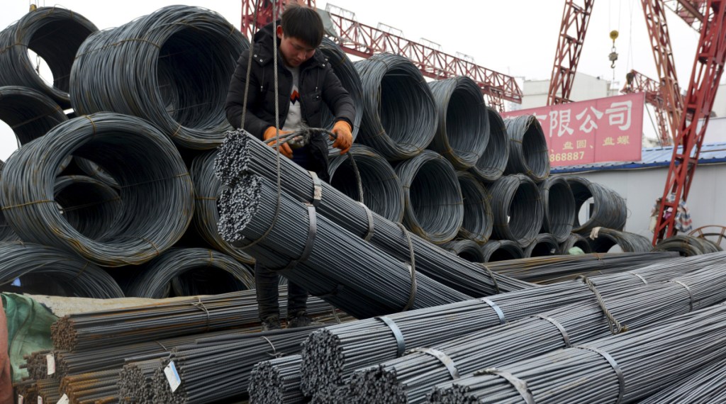 A worker loads steel products in Fuyang, China, on Friday, a day after President Trump shocked the world by saying the U.S. would impose a tariff of 25 percent on steel imports.