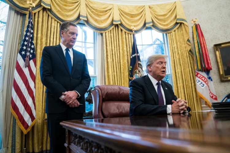 President Trump, with U.S. Trade Representative Robert E. Lighthizer, speaks in the Oval Office on Jan. 23.