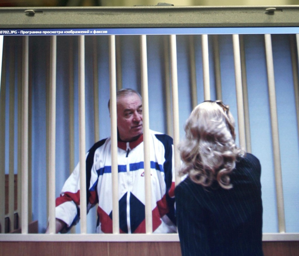 Sergei Skripal speaks to his lawyer from behind bars, as seen on the screen of a monitor outside a courtroom in Moscow in 2006.