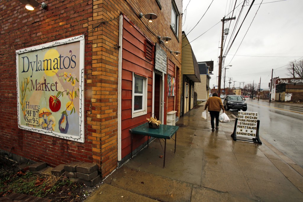 In this March 1, 2018 photo, a customer leaves Dylamatos Market owned by Dianne Shenk in Hazelwood, Pa. About a quarter of Shenk's customers pay with benefits from the federal Supplemental Nutrition Assistance Program, so the government's proposal to replace the debit card-type program with a pre-assembled box of shelf-stable goods delivered to recipients worries her and other grocery operators in poor areas. "These boxes will be full of shelf-stable items, the same things we're being told not to eat," she said. (AP Photo/Gene J. Puskar)