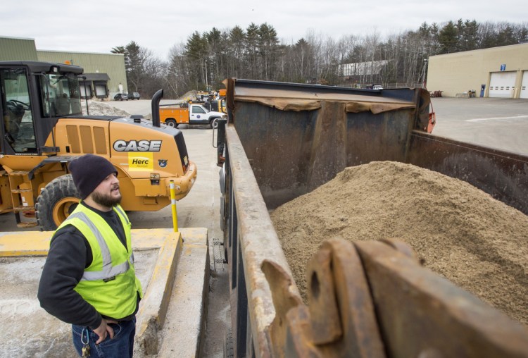 PORTLAND, ME - MARCH 6: Colby Waterhouse checks the level of mixture of sand and salt in a snow plow as city workers prepare for a winter storm expected to bring over a foot of snow to the Portland area. (Photo by Derek Davis/Staff Photographer)