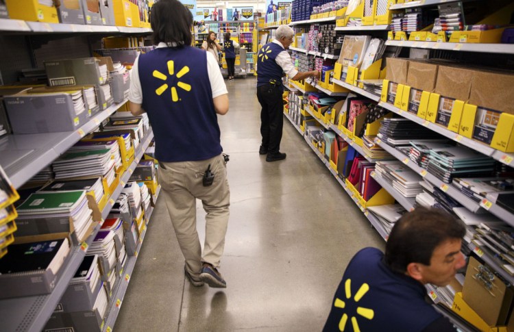 Walmart says it's paying out $400 million in bonuses and $300 million in raises because of the tax cut – but because of state minimum-wage hikes and a tight job market, it likely would have had to raise pay anyway.