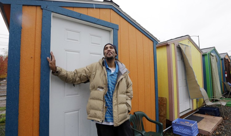 Tyson King stands at the door of his tiny house at a homeless encampment in Seattle in November. A local nonprofit started building the tiny houses, portable 120-square-foot shacks that can make up villages of 14 to 44 units. Washington state has 29 homeless people for every 10,000 state residents, according to a 2017 federal study. The national average, by comparison, is 17 people for every 10,000 residents.