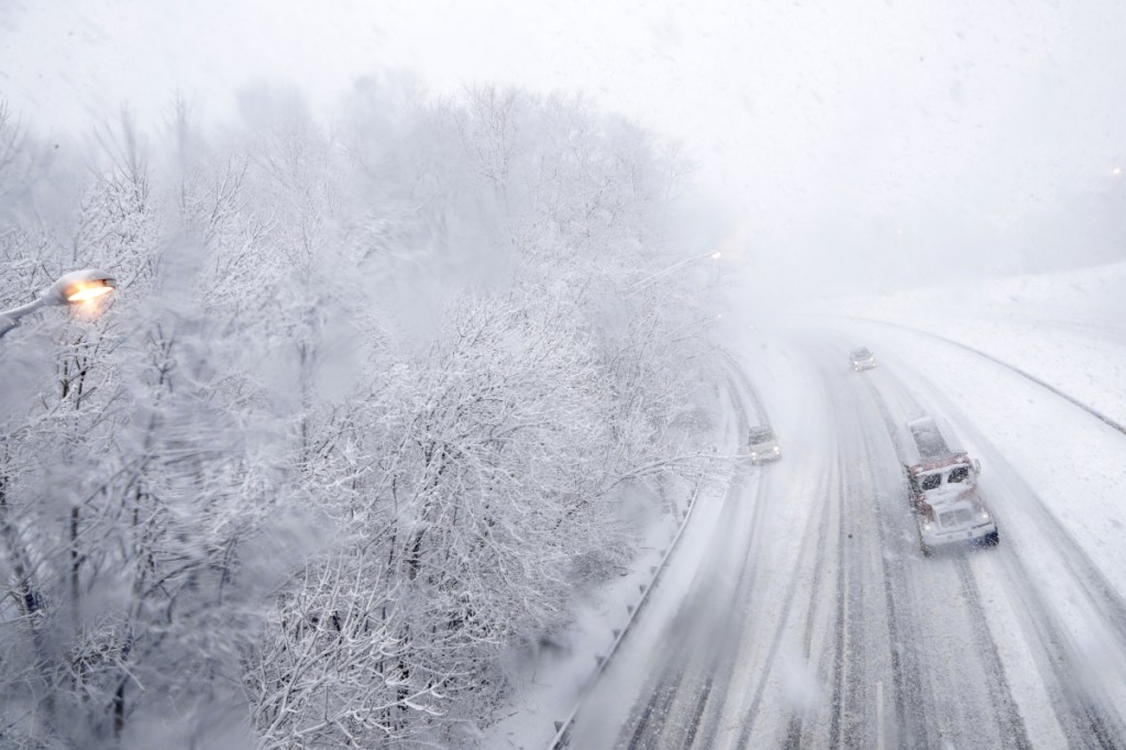 Vehicles travel northbound over a snow-covered Interstate 287 during a snowstorm Wednesday in Morristown, N.J.