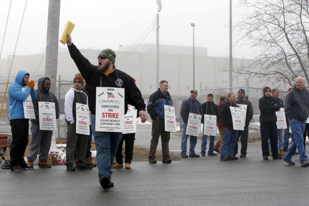 Pickets at the Hannaford distribution center in South Portland during the strike over wages and health care costs. A letter writer says employment-based health benefits go back to World War II to avoid wage controls.