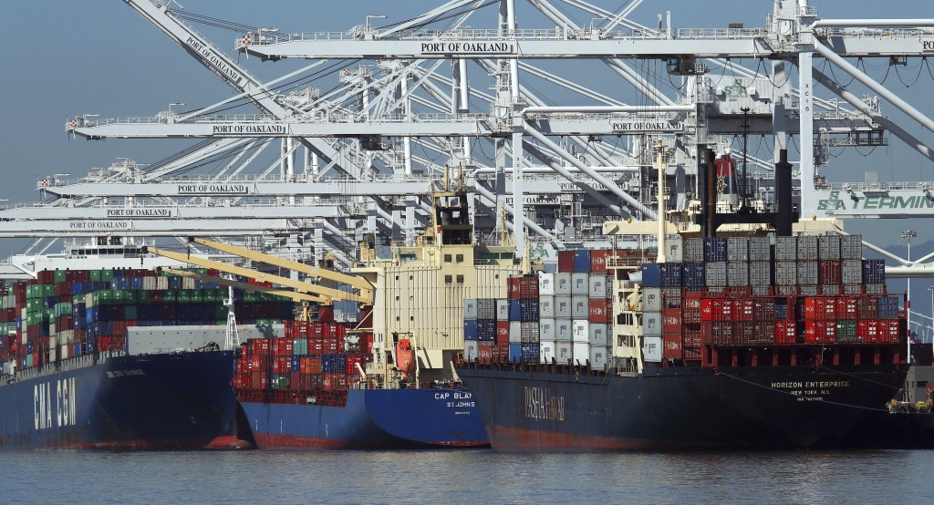Container ships wait to unload their overseas cargo at the Port of Oakland on Wednesday. The White House is expected to make a final decision on Thursday on new tariffs, which could have a significant impact on both imports and exports.